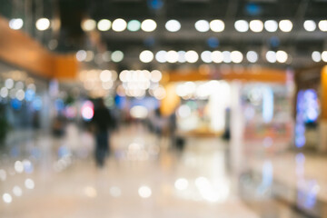 Bright defocused blurred background with unrecognizable people at the airport. Abstract image of crowd of people in public place.