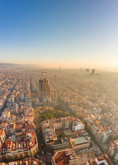 Aerial drone shot of church in Barcelona misty morning during sunrise