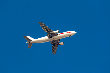 Large passenger plane flying in the blue sky