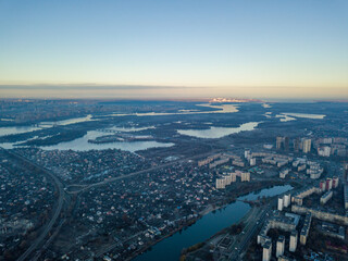 Aerial high flight over Kiev, haze over the city. Autumn morning, the Dnieper River is visible on...