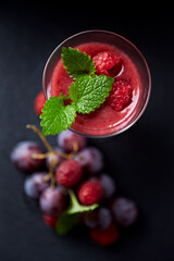 Fresh smoothie in a glass. Dark background. Top view. Close up. 