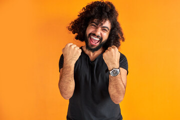 happy bearded man celebrate his winning, smile, curly guy shine with happiness, victory concept....
