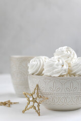 Obraz na płótnie Canvas Fresh airy handmade vanilla marshmallows in a vase against a light background. New Year's decor
