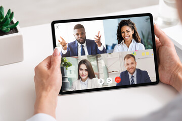 Fototapeta na wymiar Business People Having Group Video Call Online Via Tablet Indoor