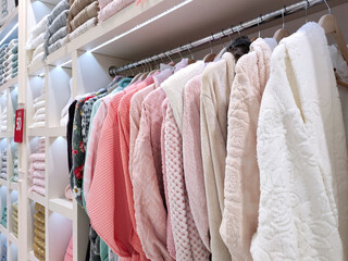 View of the bathrobes and neatly folded terry towels of various colors in the store. Concept for lifestyle, retail, discounts.