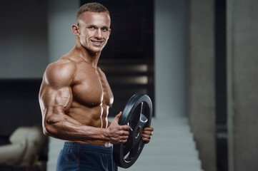 Caucasian man pumping up muscles. fitness training