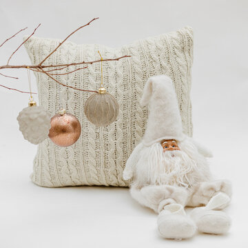 Vertical Shot Of A Pillow, A Christmas Toy, And Christmas Decorations On A White Background