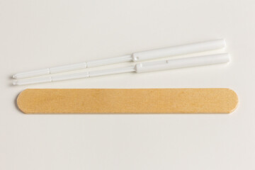 sterile coronavirus test sticks and wooden spatula