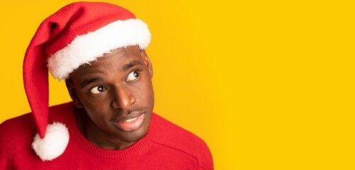 Interesting Offer. Curious African Guy In Santa Hat Overhear On Yellow Background