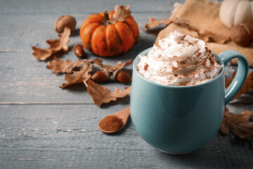 Delicious pumpkin latte on grey wooden table, closeup