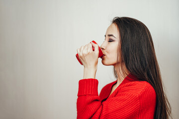 a asian girl in a red jacket and a red cup on a white background