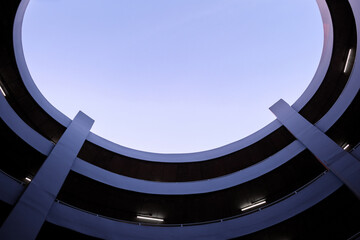 multi-level spiral car parking with blue sky.