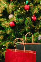 shopping bags with christmas tree in background.