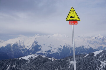 ski resort in the mountains of the French Alps with a fun sign for danger