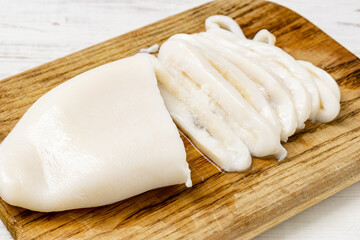 Fototapeta na wymiar Sliced raw squid on a cutting board.