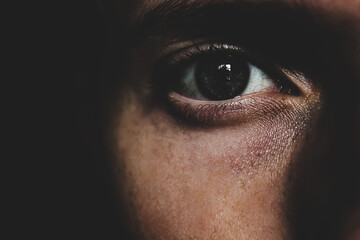 Macro image of human eye. Green eye in the dark