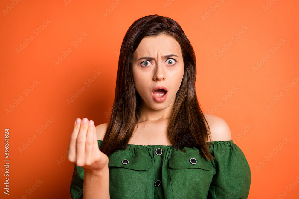 Wall mural Portrait of scared woman ask for money wear dark shirt isolated on orange color background