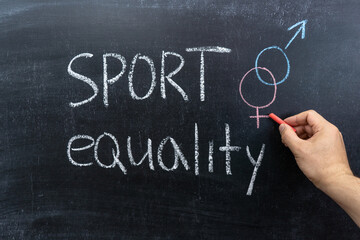The concept of gender inequality in sports, men's hand with chalk