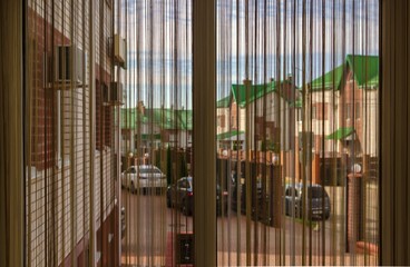 Obraz premium curtain in the lobby on the window overlooking the street