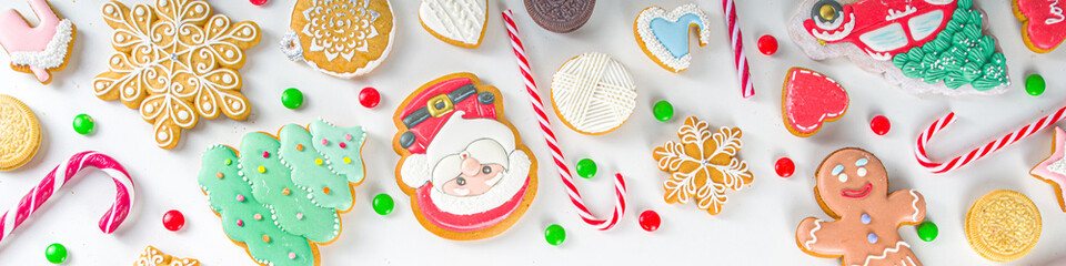 Christmas sweets set. Assorted festive Christmas and New Year sweets, traditional candy and cookie. Flatlay with candy cane candies, gingerbread, sweets, simple pattern top view
