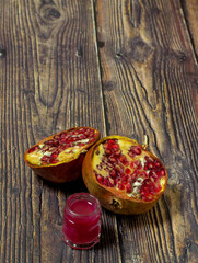 Pomegranate homemade jam. Magenta jam on a wooden background
