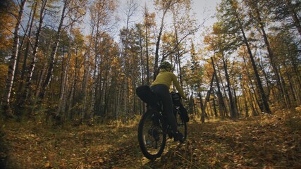Naklejka premium The woman travel on mixed terrain cycle touring with bikepacking. The traveler journey with bicycle bags. Sport tourism bikepacking.