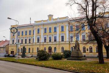 District Court, yellow building in classical style, monuments of Kolin in autumn day, Central Bohemia, Czech Republic