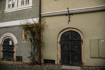 Narrow picturesque street with colorful buildings in old historic center in Kolin, baroque house with wrought iron doors, Bohemia, Czech Republic