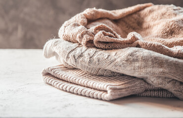 A stack of knitted sweaters ,the concept of warmth and comfort, hobby , background - 396376851