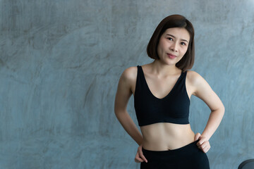 Fototapeta na wymiar Close up asian beautiful sport girl on wall of gym,Thailand love health,Slim woman workout concept