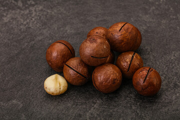 Brown macadamia nut heap over background