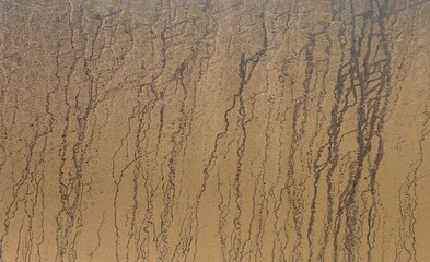 Texture of a very dirty door of a grey car covered by mud washed by rain