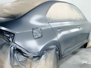 Car at the stage of painting in the workshop