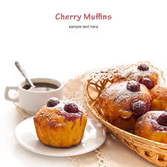 Homemade Cherry Muffins in a wicker basket with a cup of coffee on a white background