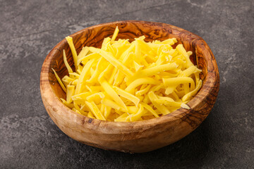 Shredded yellow cheese in the bowl