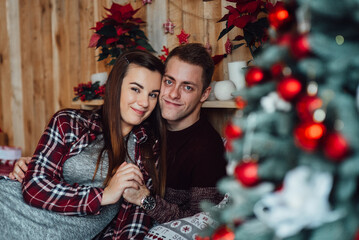 a guy and a girl celebrate the new year together. and give each other gifts