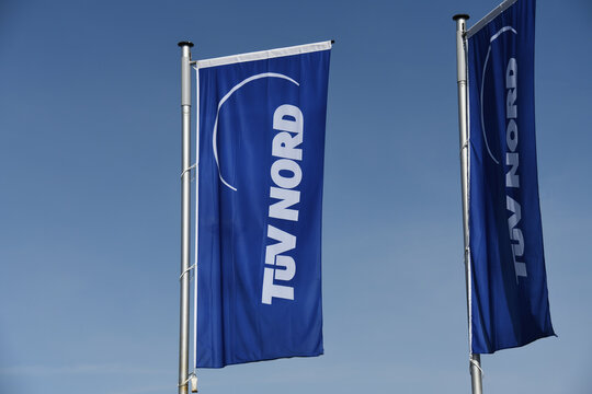 Celle, Lower Saxony, Germany - April 10, 2020:  Flags with the TUV Nord logo (Technical Inspection Association) in Celle, Germany - T&Uuml;V Nord is a technical service provider with worldwide activities