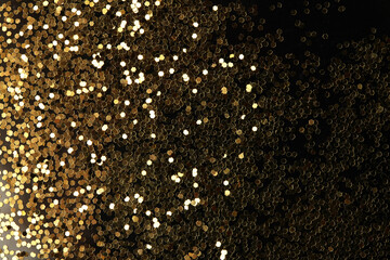 Gold (bronze) glitter shine dots confetti on black.  Abstract light blink sparkle horizontal...