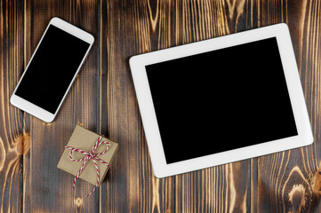 Smartphone, tablet, gift on a wooden background.Congratulations on the holiday,Valentine's day.