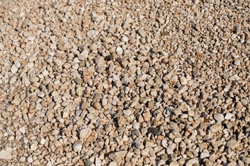 Endless wet sea pebbles background texture, natural stones background