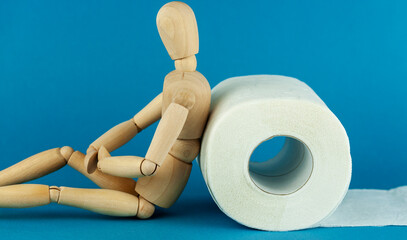 the wooden man and a roll of toilet paper, digestive problems