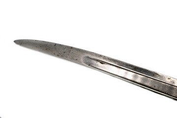 the edge of an antique blade on a white background
