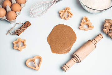 Fototapeta na wymiar Shortcrust pastry for gingerbread.Christmas background for baking, top down view, copy space. Christmas and New Years, family celebration traditions. cinnamon, spices, flour on a white table.