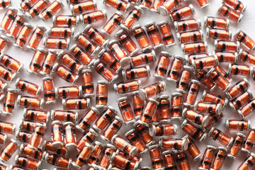 Smd components abstract background. Small surface mound sod-80 glass orange diode arranged...