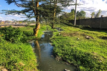 Filty water flowing next to a highway in Nairobi, Kenya