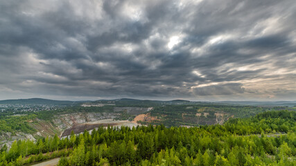 Fototapeta na wymiar landscape with old quarry and cloudy sky