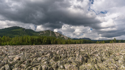 scattering of stones with forest and high hills