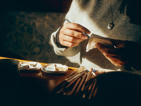 artist's hands and materials in the sun