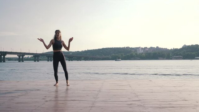 sports girl dancing on the pier