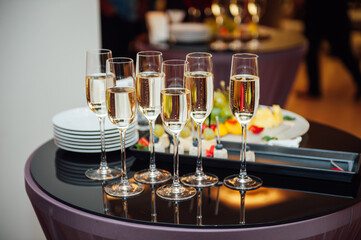 Fototapeta na wymiar Glasses of champagne at the Banquet, white sparkling wine in wine glasses, festive mood